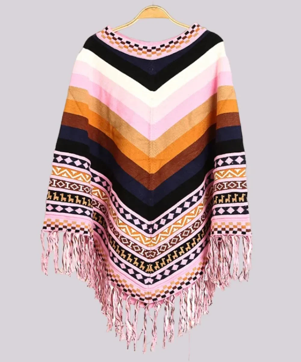 Poncho femme péruvien coloré à motifs géométriques, rayures roses et oranges, franges au bas.