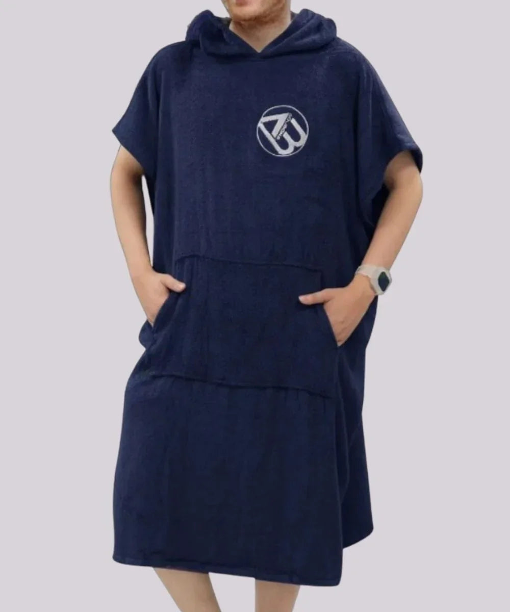 Homme portant un poncho de bain surf bleu marine à capuche et poche frontale.